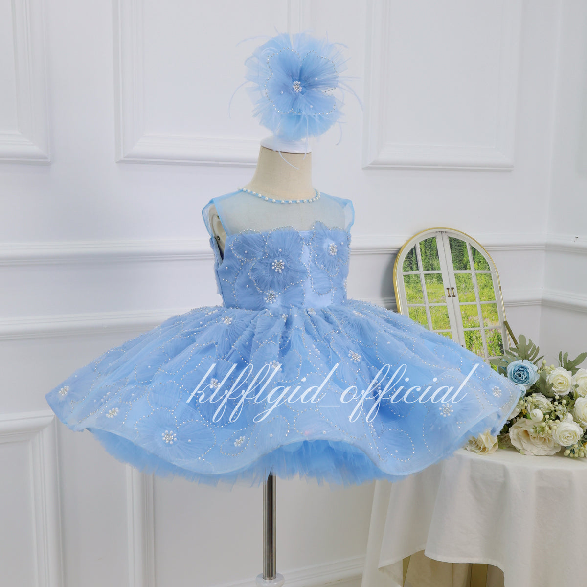 Baby blue floral princess gown for girls with dimensional flower details and a voluminous layered tulle skirt side view