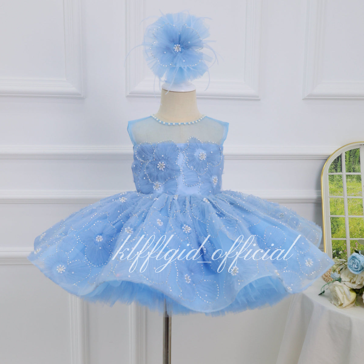 Baby blue princess dress for girls with 3D floral bodice, pearl-like neckline details and embroidered tulle skirt front view