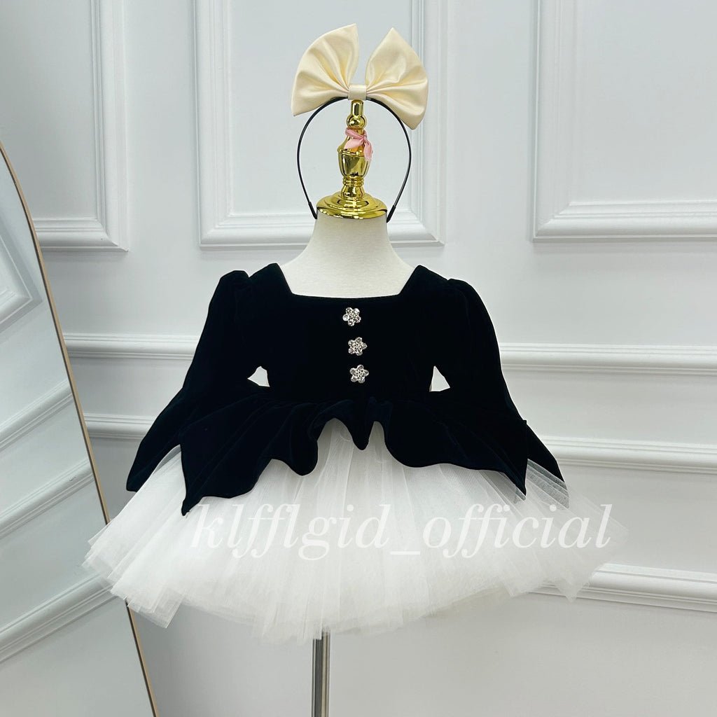 Black velvet princess dress for girls with three floral buttons and a full white tulle skirt.