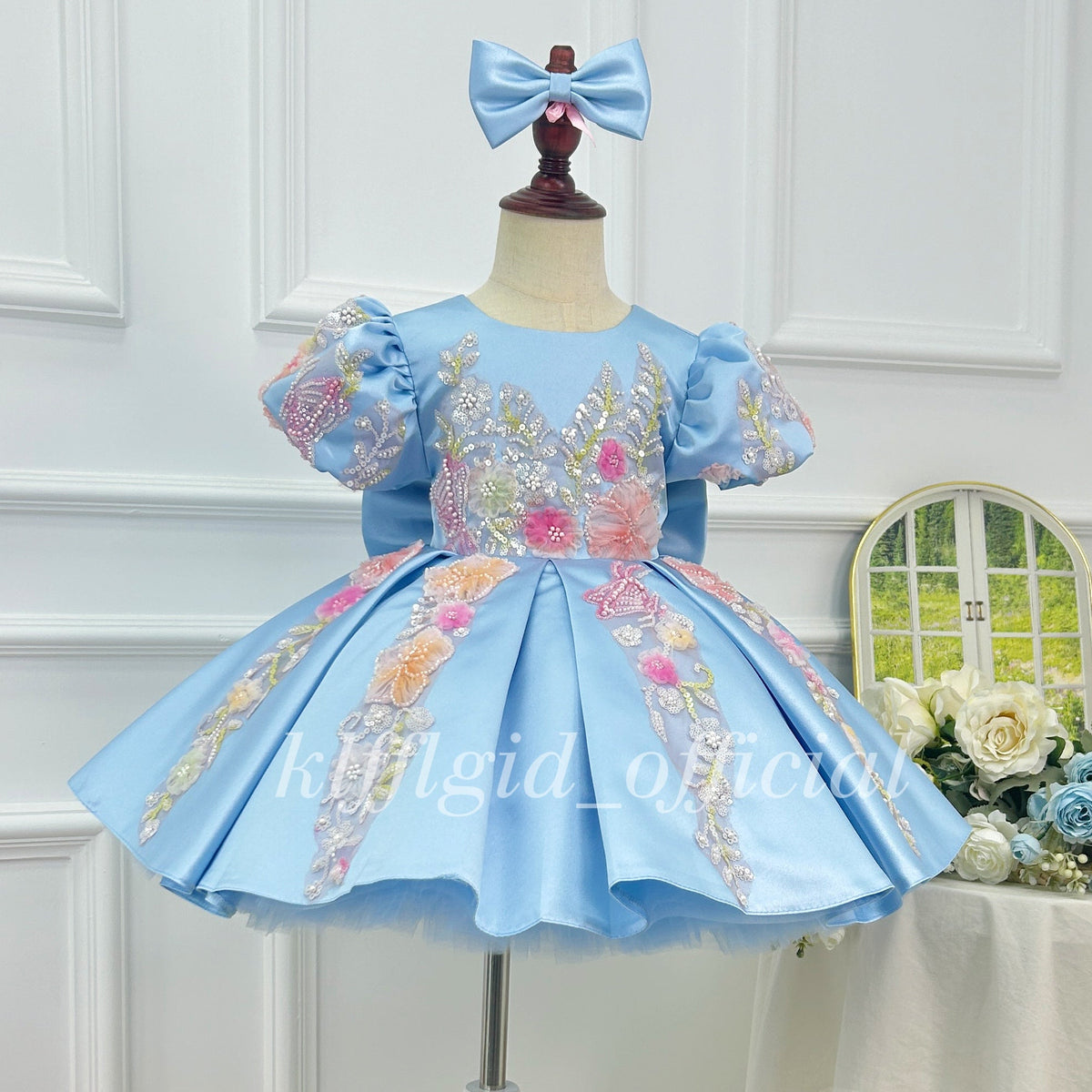 Light blue satin princess dress for girls with pink floral embroidery, puff sleeves and a full skirt