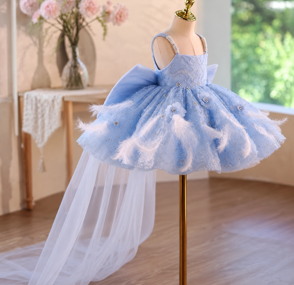 Blue princess tulle dress with feather embellishments, floral accents and flowing train detail
