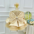 Champagne girls princess dress featuring a large embellished butterfly bow on the back
