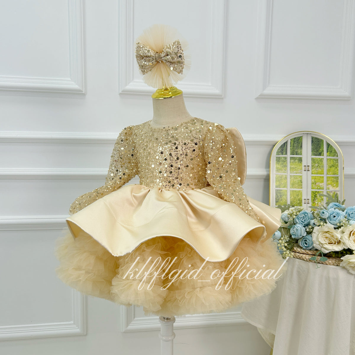 Champagne sparkly princess dress for girls with satin waist detail and layered tulle skirt three-quarter view