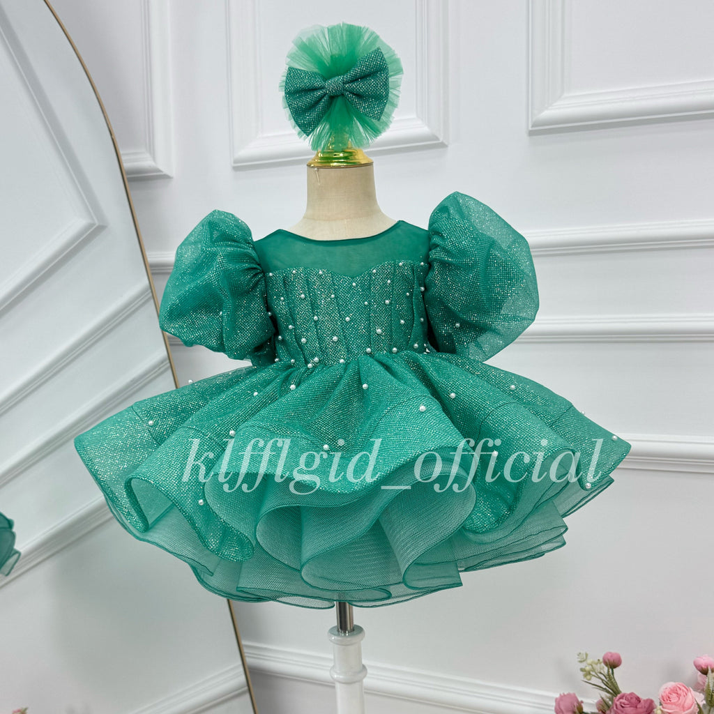 Emerald green girls' princess dress with oversized puff sleeves, pearl embellishments, a sheer neckline, and a voluminous glitter tulle skirt
