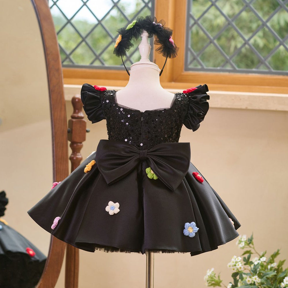 Back view of black girls princess dress with large bow and floral appliques