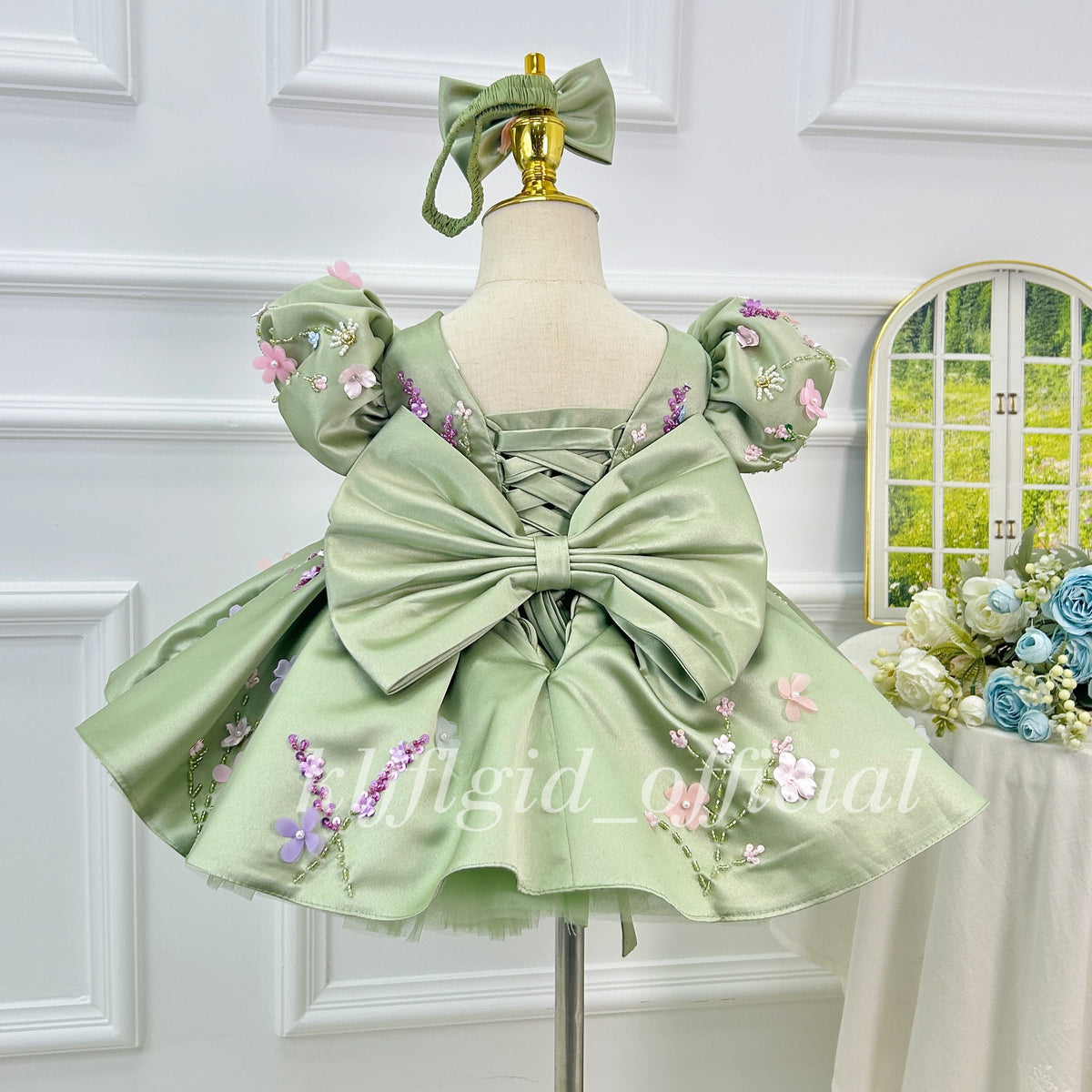 Green girls princess dress back view with oversized bow and floral embroidery details
