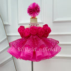 Front view of a hot pink girls' princess dress with dimensional floral decorations, puff sleeves, a full skirt, and a dramatic sheer train.