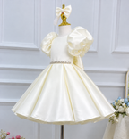 Three-quarter view of an ivory princess birthday dress for girls with voluminous ruffled sleeves, a jeweled waistline, and a structured satin skirt