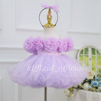 Front view of a lavender first birthday dress for girls with oversized 3D floral bodice decorations, a full layered tulle skirt, and a matching bow headband.