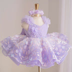 Lavender girls princess dress with diagonal bodice, dimensional floral appliqués, pearl accents, fluffy tulle shoulders and layered floral skirt