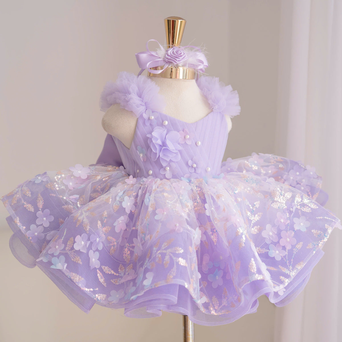Lavender girls princess dress with diagonal bodice, dimensional floral appliqués, pearl accents, fluffy tulle shoulders and layered floral skirt