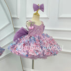 Side view of a lavender girls' party dress with a sparkling sleeveless bodice, colorful three-dimensional floral decorations, a full layered skirt, and a large purple bow.
