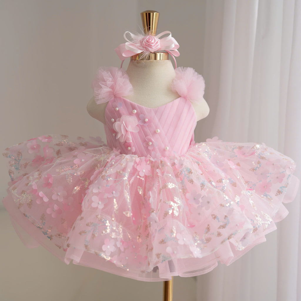 Pink girls floral princess tutu dress with diagonal bodice, pearl embellishments, fluffy tulle shoulders and colorful floral layered skirt