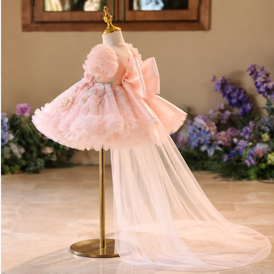 Side view of pink floral princess dress for girls with layered floral skirt, large bow and flowing tulle train
