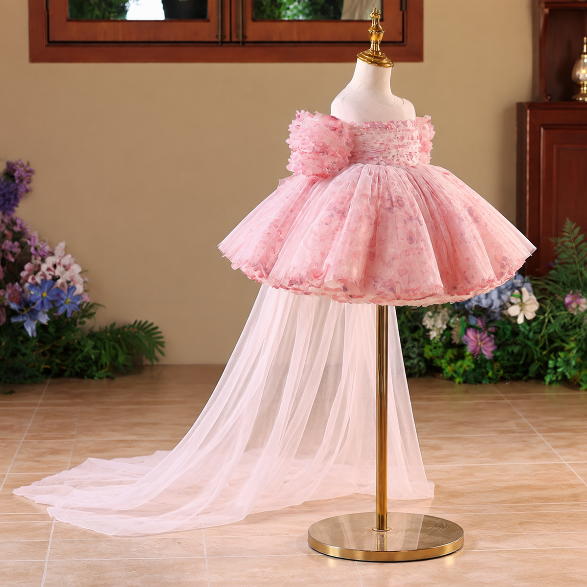 Pink floral tulle princess dress for girls shown at an angle with puff sleeves and flowing train
