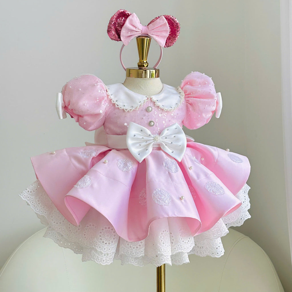 Pink polka dot princess dress for girls with embellished puff sleeves, white collar, decorative waist bow and layered lace hem