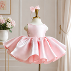 Pink satin princess dress for girls with a sleeveless bodice and voluminous flared skirt, front view.