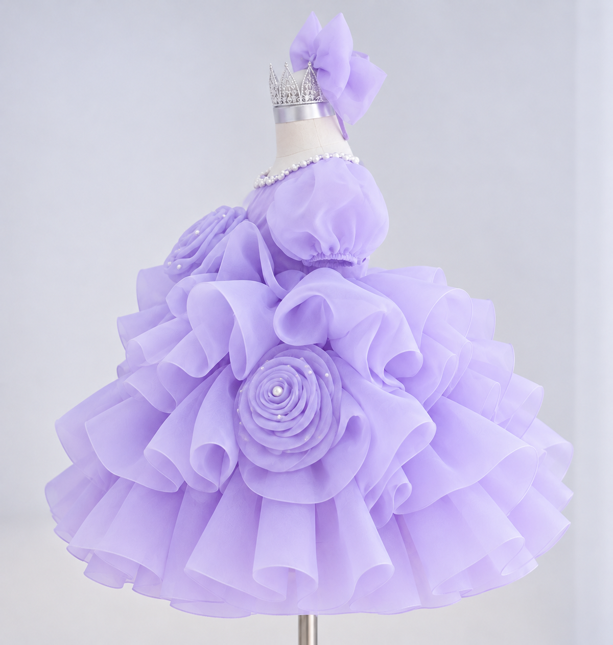 Side view of purple girls tutu princess dress with voluminous layered ruffles, rose embellishments and puff sleeves