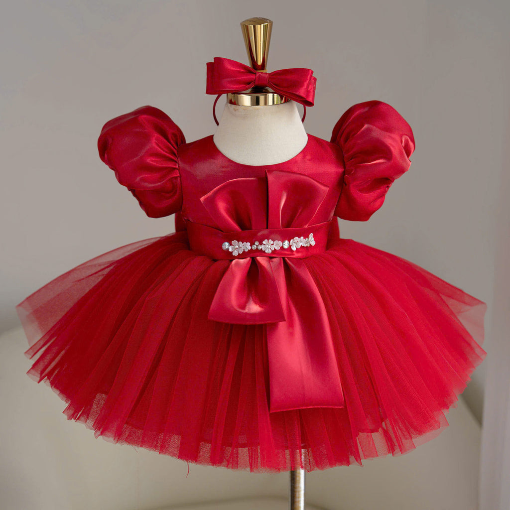 Red satin birthday princess dress for girls with puff sleeves, decorative bodice bow, jeweled waist embellishment and full tulle skirt