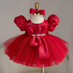 Red satin birthday princess dress for girls with puff sleeves, decorative bodice bow, jeweled waist embellishment and full tulle skirt