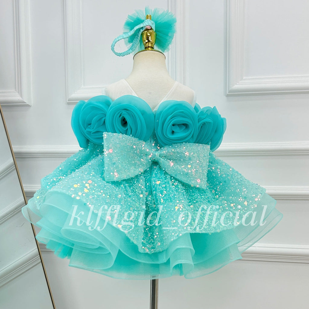 Turquoise rose princess birthday dress for girls with oversized fabric roses, glittering sequin overlay, and a layered skirt
