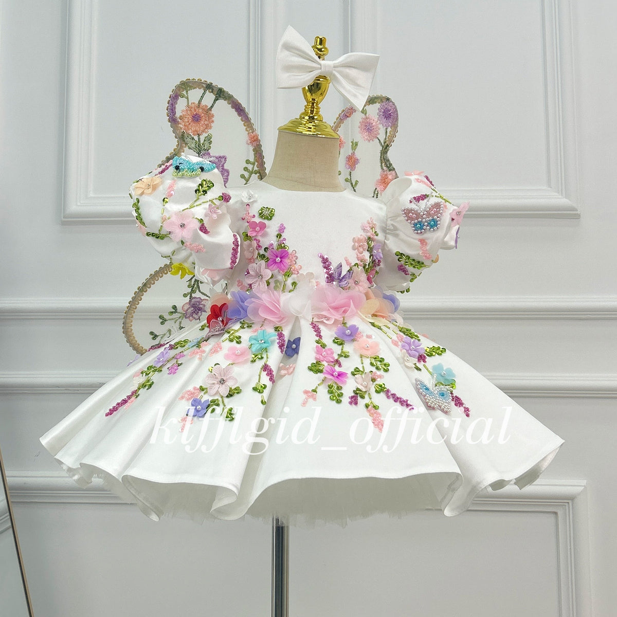 White princess dress for girls with colorful floral embroidery and layered flower waist detail