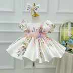 White floral embroidered girls princess dress three quarter view with puff sleeves and elegant silhouette