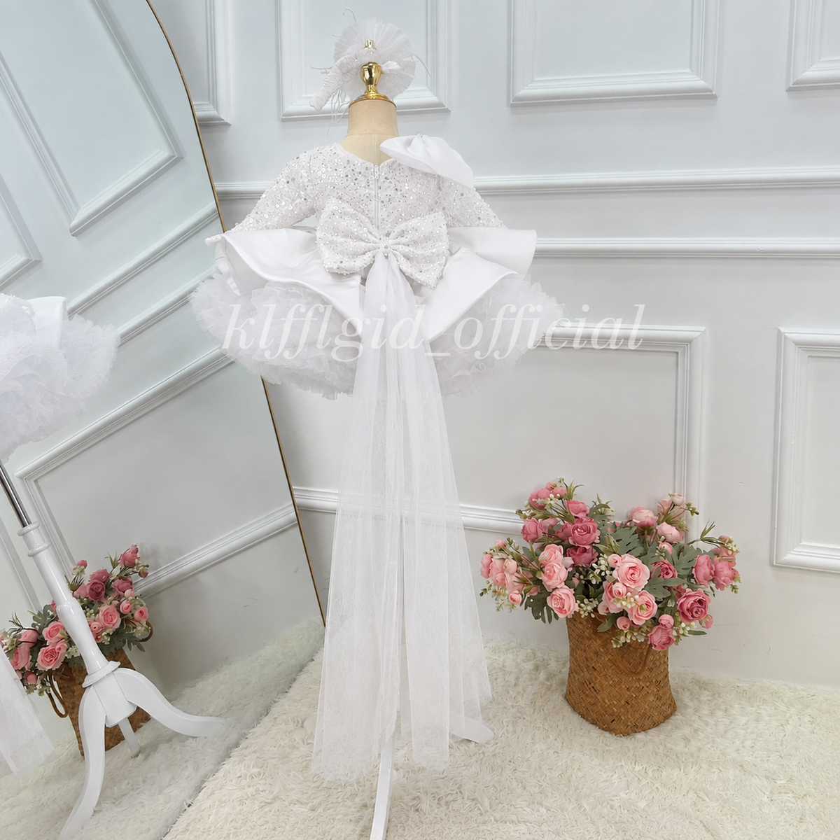 White girls princess dress back view with bow detail and flowing sheer tulle train
