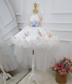 Full-length white girls princess dress with colorful floral embroidery and a flowing sheer tulle veil