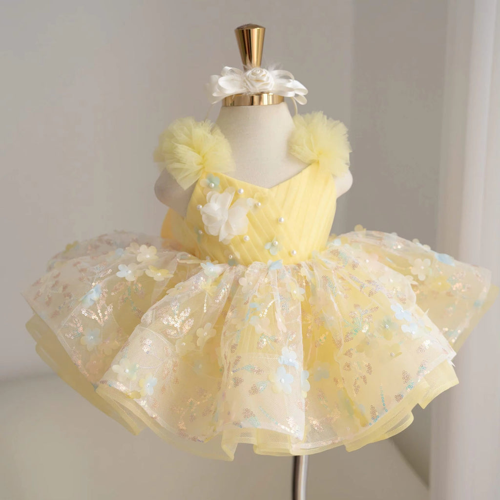 Yellow girls princess tutu dress with diagonal bodice, 3D white flower appliqués, pearl accents and colorful floral sequin skirt