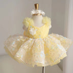 Yellow girls princess tutu dress with diagonal bodice, 3D white flower appliqués, pearl accents and colorful floral sequin skirt
